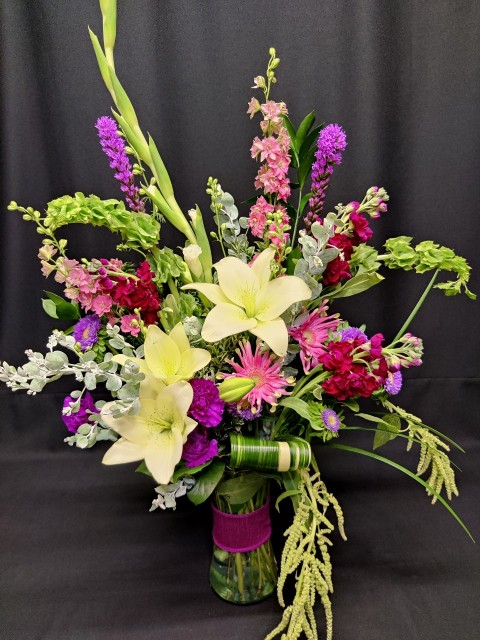Romantic bouquet of lilies unique flowers and dripping amaranth 